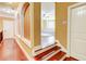 View from the hallway into the brightly lit living room with hardwood floors at 116 Archstone Sq, Mcdonough, GA 30253