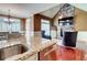 Open kitchen and living area with a kitchen island, dining table, and stone fireplace at 116 Archstone Sq, Mcdonough, GA 30253