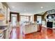 Bright kitchen with granite countertops, hardwood floors, stainless appliances, and a dining area at 116 Archstone Sq, Mcdonough, GA 30253