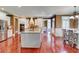 Kitchen featuring white cabinets, a center island, stainless steel appliances, and hardwood flooring at 116 Archstone Sq, Mcdonough, GA 30253