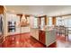 Kitchen with a central island, stainless steel appliances, granite countertops, and hardwood floors at 116 Archstone Sq, Mcdonough, GA 30253