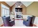 Living room with stone fireplace, vaulted ceiling, wood floors, and plantation shutters at 116 Archstone Sq, Mcdonough, GA 30253