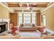 Comfortable living room featuring a stone fireplace and a bay window with plantation shutters at 116 Archstone Sq, Mcdonough, GA 30253