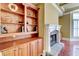 Close up view of a stone fireplace with built in shelving in a stylish living room at 116 Archstone Sq, Mcdonough, GA 30253