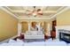 Elegant living room with coffered ceilings, archways, and a stone fireplace at 116 Archstone Sq, Mcdonough, GA 30253