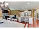 Open floor plan with kitchen bar, dining table, fireplace and adjacent living room at 116 Archstone Sq, Mcdonough, GA 30253