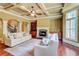 Spacious living room featuring coffered ceilings, fireplace and staircase in background at 116 Archstone Sq, Mcdonough, GA 30253