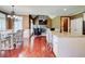 Open layout with dining area, kitchen island, and a living area with a stone fireplace at 116 Archstone Sq, Mcdonough, GA 30253