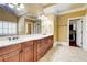 Light-filled bathroom with double sink vanity and generous counter space provides a spa-like experience at 116 Archstone Sq, Mcdonough, GA 30253