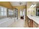 Inviting bathroom features a jetted tub, large shower, and access to the main bedroom at 116 Archstone Sq, Mcdonough, GA 30253