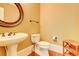 Charming powder room featuring a pedestal sink, toilet, and stylish accents at 116 Archstone Sq, Mcdonough, GA 30253