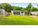 The large, green backyard showcases the home's outdoor space with a modern sunroom addition at 1981 Shalimar Ne Dr, Atlanta, GA 30345
