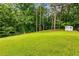 The expansive green backyard is framed by mature trees and features a practical storage shed at 1981 Shalimar Ne Dr, Atlanta, GA 30345