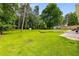 Expansive backyard featuring lush green grass and mature trees offering serene outdoor space at 1981 Shalimar Ne Dr, Atlanta, GA 30345