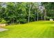 A large grassy backyard is lined with mature trees and includes a white storage shed at 1981 Shalimar Ne Dr, Atlanta, GA 30345