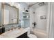 This bathroom features a white tile shower, marble countertops and silver hardware at 1981 Shalimar Ne Dr, Atlanta, GA 30345