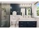This bathroom features a vanity with double sinks, brass fixtures and a tiled glass shower at 1981 Shalimar Ne Dr, Atlanta, GA 30345