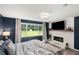 Bedroom with decorative fireplace, large window and wood floors at 1981 Shalimar Ne Dr, Atlanta, GA 30345