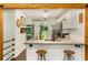 Charming kitchen featuring a breakfast bar, white cabinets, and stainless steel appliances at 1981 Shalimar Ne Dr, Atlanta, GA 30345