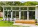 Cozy sunroom with large windows, outdoor seating, and views of the landscaped backyard at 1981 Shalimar Ne Dr, Atlanta, GA 30345