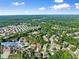 Community aerial view showcasing a neighborhood with mature trees, community pool, and a glimpse of the featured home at 5157 Sunlake Dr, Hoschton, GA 30548