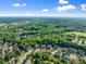 Aerial view of lush green trees surrounding a neighborhood in a suburban landscape at 5157 Sunlake Dr, Hoschton, GA 30548
