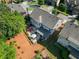 Aerial view of home features landscaped yard, fire pit and patio at 5157 Sunlake Dr, Hoschton, GA 30548