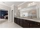 Bathroom showcasing a double vanity, walk-in shower, and view into the main bedroom at 5157 Sunlake Dr, Hoschton, GA 30548