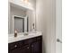 This well-lit bathroom features a brown vanity with a white countertop and a large mirror at 5157 Sunlake Dr, Hoschton, GA 30548
