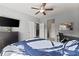 This bedroom features a ceiling fan, a dresser with a TV, and a comfortably made bed at 5157 Sunlake Dr, Hoschton, GA 30548