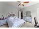 Comfortable bedroom with dresser and attached bath access to the hall bathroom at 5157 Sunlake Dr, Hoschton, GA 30548