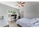 Comfortable bedroom showcasing a desk and view to the rear of the property at 5157 Sunlake Dr, Hoschton, GA 30548