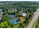 Aerial view of community amenities: tennis courts and a large swimming pool at 5157 Sunlake Dr, Hoschton, GA 30548