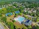 Aerial view of community amenities: tennis courts, pool and clubhouse at 5157 Sunlake Dr, Hoschton, GA 30548