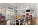 Dining area with hardwood floors, coffered ceilings, and views into the cozy living room at 5157 Sunlake Dr, Hoschton, GA 30548