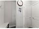 Welcoming entryway featuring a clock, key rack, coat rack, and built in storage at 5157 Sunlake Dr, Hoschton, GA 30548