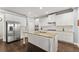 Kitchen with a center island, granite countertops, stainless steel appliances, and white cabinets at 5157 Sunlake Dr, Hoschton, GA 30548
