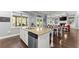 Kitchen island with granite countertops, stainless steel dishwasher, and views to the dining and living rooms at 5157 Sunlake Dr, Hoschton, GA 30548