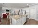 Open-concept kitchen with granite countertops, stainless steel appliances, and views of the living area at 5157 Sunlake Dr, Hoschton, GA 30548