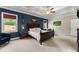Spacious main bedroom features a tray ceiling, ceiling fan, and large windows at 5157 Sunlake Dr, Hoschton, GA 30548