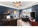 Comfortable home office with hardwood floors, custom shelving, and a large window with natural light at 5157 Sunlake Dr, Hoschton, GA 30548