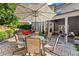 Outdoor patio features a dining table with umbrella and beautiful landscaping at 5157 Sunlake Dr, Hoschton, GA 30548