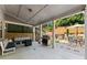 This covered patio is perfect for outdoor living with a seating area, kitchen, and a grill at 5157 Sunlake Dr, Hoschton, GA 30548