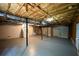 Unfinished basement with exposed ceiling, utilities, and walkout double door at 52 Tide Water Way, Rockmart, GA 30153