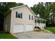 View of the home featuring an attached two-car garage, front porch, and complemented by a well-maintained lawn at 52 Tide Water Way, Rockmart, GA 30153