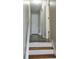 Hallway featuring hardwood floors and neutral paint with stairs leading to the upper level at 52 Tide Water Way, Rockmart, GA 30153