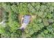 Aerial view of a home surrounded by lush, mature trees and a long driveway at 83 Shipp Cir, Hiram, GA 30141