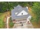 Aerial view of a two-story home surrounded by mature trees, featuring a full-length porch and beautifully landscaped yard at 83 Shipp Cir, Hiram, GA 30141
