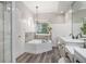 Bright bathroom showcasing a soaking tub, separate shower, and dual vanities at 83 Shipp Cir, Hiram, GA 30141