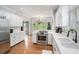 Well-appointed kitchen with white cabinetry, hardwood floors, and a view to the outdoors at 83 Shipp Cir, Hiram, GA 30141